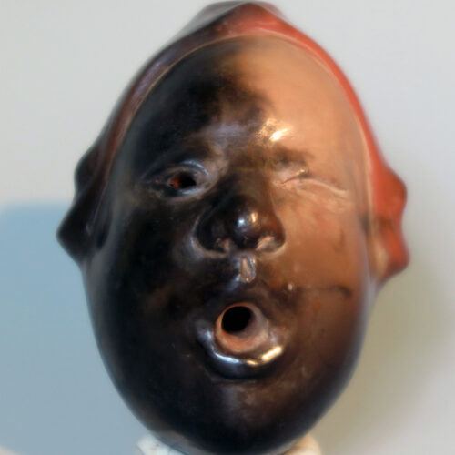 Ocarina in the form of a face with closed eyes